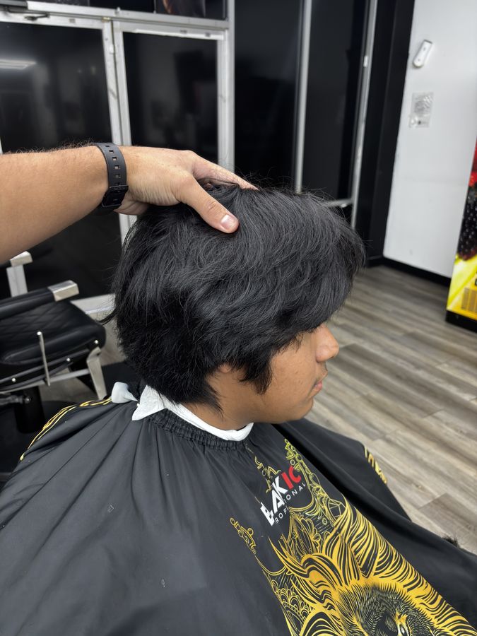 Cliente joven antes del corte, con el pelo largo y abultado